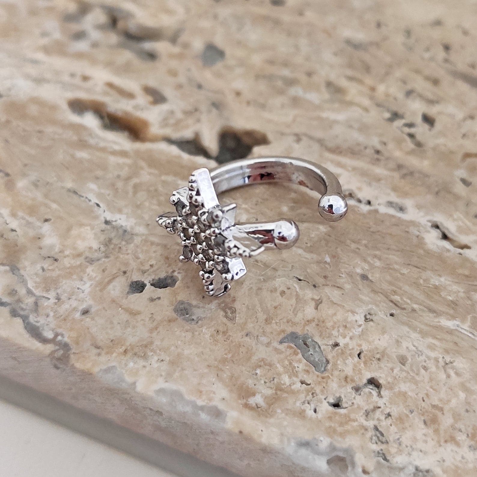 Polar star cartilage earrings with gold-tone zircon stones on brass